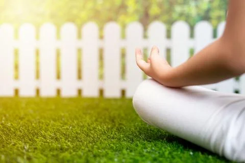 Close up of child practicing yoga pose on a mat Stock Photos