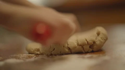 Close-up of child starting to roll dough Stock Footage 336374523