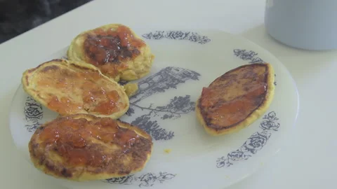 Close-up of child taking a bite of a pancake with jam Stock Footage 331597408