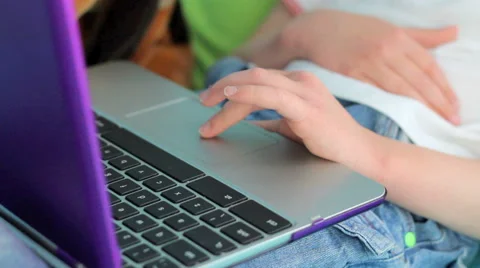 Close up child typing and using mousepad on laptop Stockbeeldmateriaal 42177365