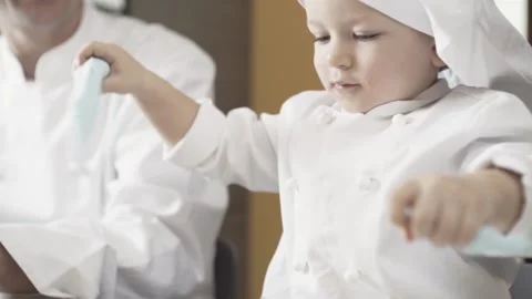 Close-up of child using his hands cutting blue sugar paste. Handcrafted products 動画素材 170114633