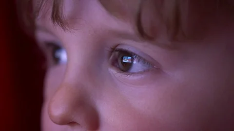 Close up child watching cartoons Stock Footage 74772664