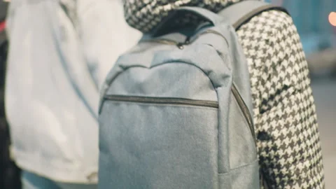 Close-up of child wearing houndstooth jacket with light blue backpack Stock Footage 317934938