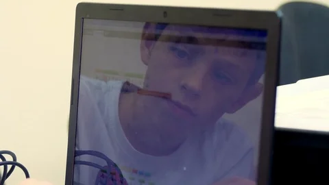 Close-up, a child working on a laptop. the face of the child is reflected in the Video stock 118846336