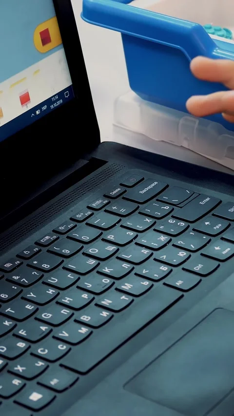 Close-up, a child working on a laptop, typing on a keyboard. school and Video stock 318352492