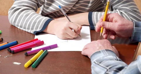Close-up of children and elderly hands drawing tic-tac-toe on paper. Home Stock Footage 151010538