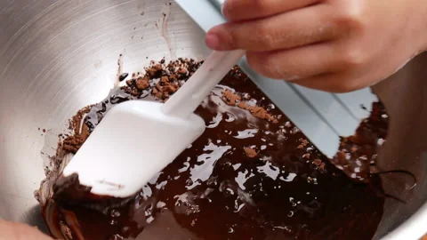 Close up of children hands using a ladle to dissolve cocoa powder in warm water. Stock Footage 158659833