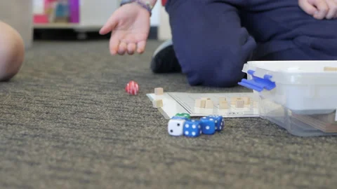 CLOSE UP Children In Maths Class Rolling Dice And Counting Blocks Stock Footage 139550022