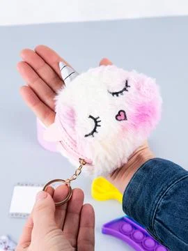 Close-up of a children's fur multi-colored wallet in the form of a unicorn wi Foto stock