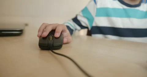 Close-up children's hand use computer mouse. 4K 10-bit Stock Footage 346556994