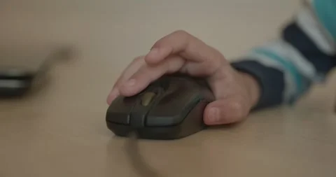Close-up children's hand use computer mouse. 4K 10-bit Stock Footage 346557011