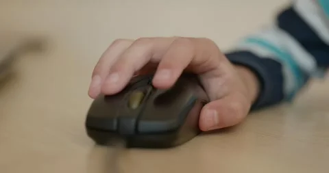 Close-up children's hand use computer mouse. 4K 10-bit Stock Footage 346557026