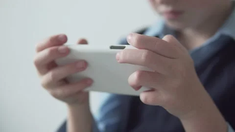 Close-up of children's hands and mobile phone. Video stock 139608759