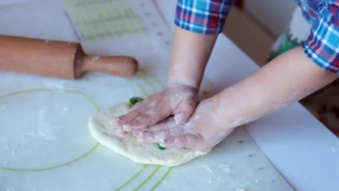 Close-up of children's hands cutting out cookies from dough Видео 331257687