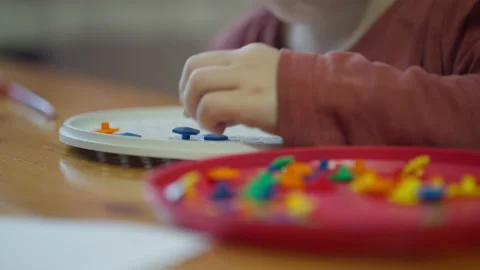 Close-up of children's hands fitting puzzle pieces together at home Stock Footage 194511450