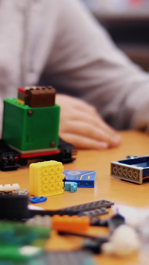 Close-up, children's hands hold a multicolored small robot, machine, assembled Stock Footage 316986161