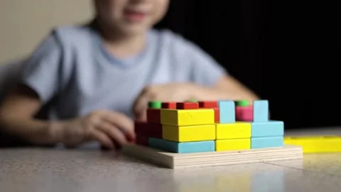Close-up of children's hands playing with an educational puzzle toy Stock Footage 232570137