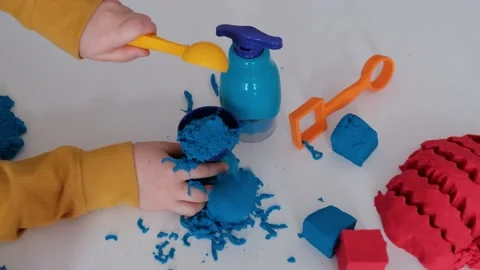 Close up of childrens hands playing with kinetic sand Stock Footage 148396519