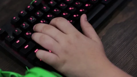 Close-up of children's hands typing on a keyboard. Selective focus. Stock Footage 113600398