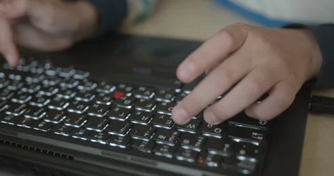 Close-up children's hands typing on laptop computer keyboard. 4K 10-bit Stock Footage 346554768