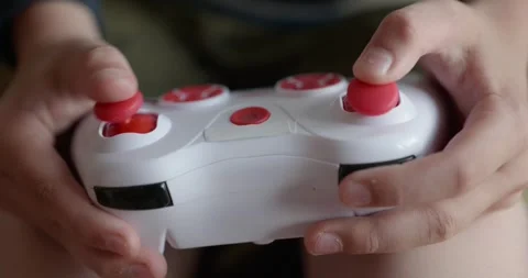 Close-up children's hands use joystick game controller playing video games. 4K Stock Footage 346603562
