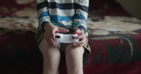 Close-up children's hands use joystick game controller playing video games. 4K Stock Footage 346603594