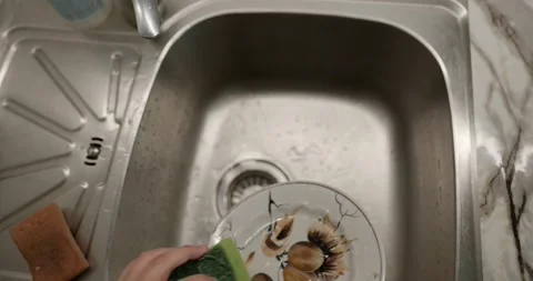 Close-up children's hands wash kitchen utensils sink and dishes. 4K  Stock Footage 345448248