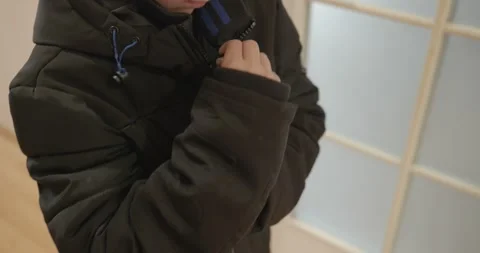 Close-up children's hands zipping zip jacket. 4K 10-bit Stock Footage 346598654