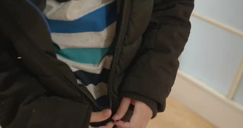 Close-up children's hands zipping zip jacket. 4K 10-bit Stock Footage 346598701