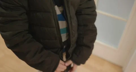 Close-up children's hands zipping zip jacket. 4K 10-bit Stock Footage 346598737
