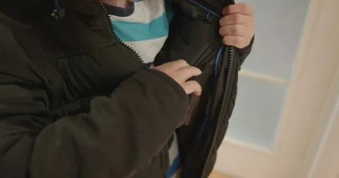 Close-up children's hands zipping zip jacket. 4K 10-bit Stock Footage 346598775