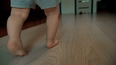 Close-up of children's legs taking their first steps Stock Footage 111725692