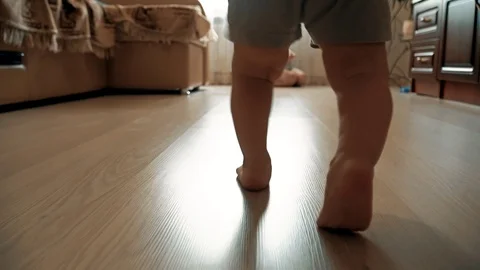 Close-up of children's legs taking their first steps Stock Footage 111725871