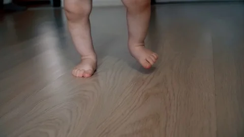 Close-up of children's legs taking their first steps Stock Footage 111726034