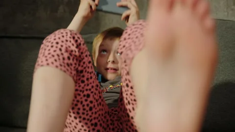 Close-up of a child's emotions while playing on the phone Stock Footage 200989714