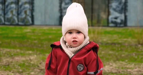 Close-up of a child's face in a hat in spring in a green park Stock Footage 274093721