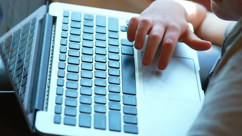 Close up of child’s hand on laptop  doing schoolwork at home Stock Footage 129641460