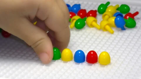 Close up of child's hand playing with mosaic Stock Footage 66238035