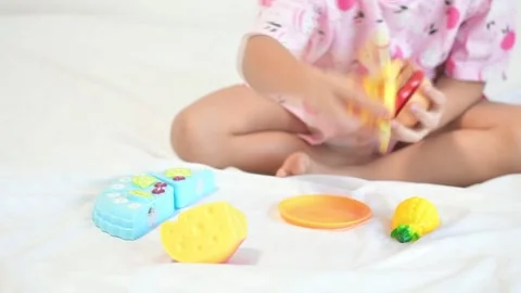 Close-up of child's hand playing with plastic toys Stock Footage 171478449