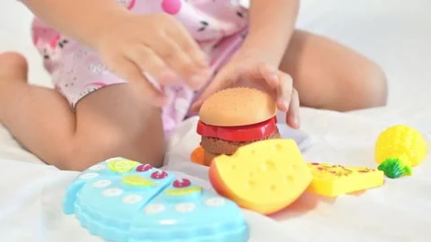 Close-up of child's hand playing with plastic toys Stock Footage 171680449