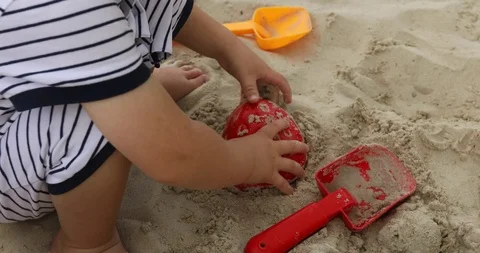 Close up of a child's hand playing sand toys Stock Footage 94100265