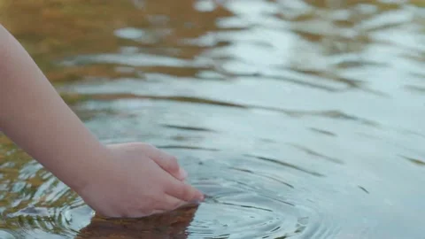 Close-up of a child's hand playing with water. Stock Footage 166221276