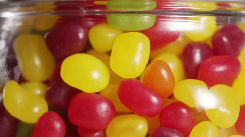 Close up of a child's hand taking a handful of candy from a sweet jar Stock Footage 57309433