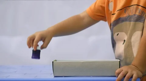 Close up of child's hand taking out of the box colorful paint Stock Footage 50265423