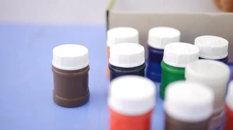 Close up of child's hand taking out of the box colorful paint in slow motion Stock Footage 50265967