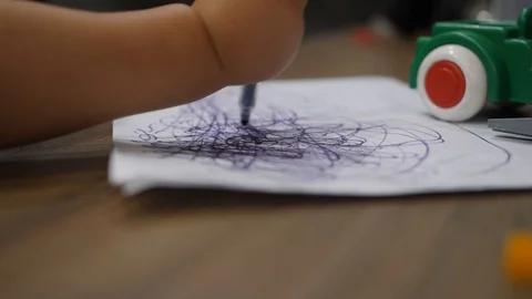 Close up of child's hands drawing scribblings with a soft-tip marker on white 스톡 동영상 97494490