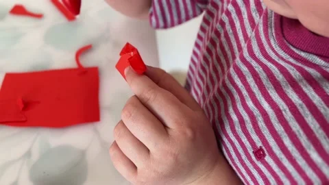A close-up of the child's hands glue colored paper. The concept of Children's Stock Footage 238515017