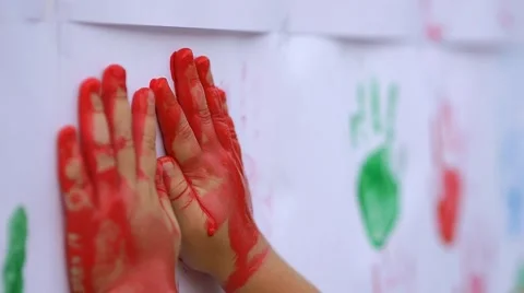 Close up of child's hands making color handprints on the wall in slow motion Stock Footage 50267959