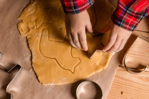 Close-up of a child's hands rolling out cookie dough for Christmas Stock Photos
