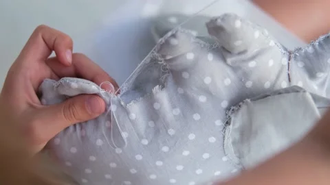 Close-up of a child's hands sewing a soft toy. Stock Footage 217960670